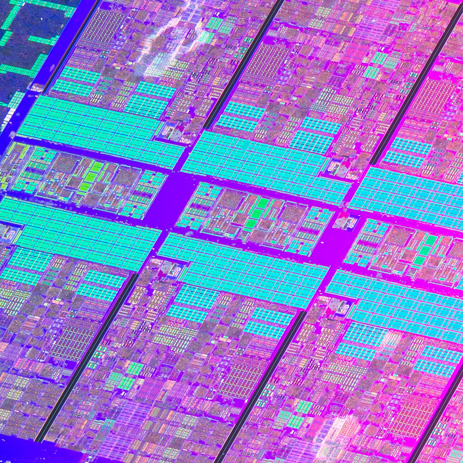 An extreme closeup of a computer chip shows various circuits and devices.