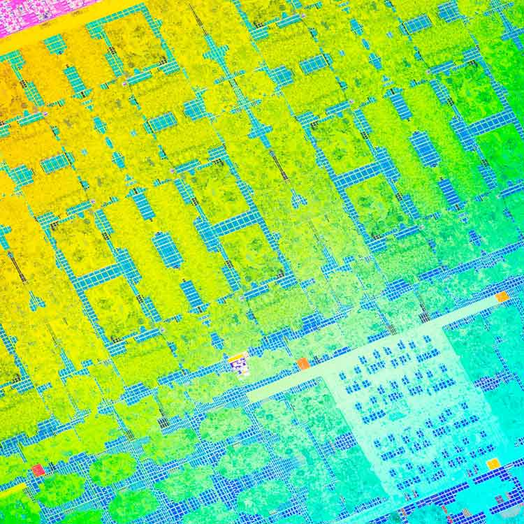 A colorful close-up of a semiconductor chip.