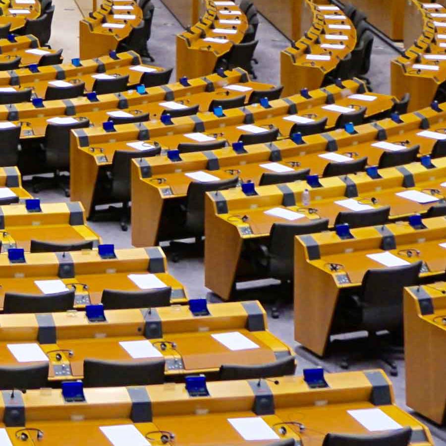 Seats arranged in rows in a legislative assembly hall.